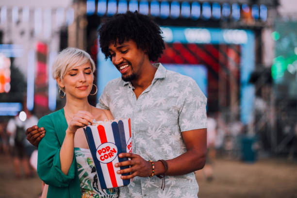 istock Mixed race couple eating popcorn 1173211320