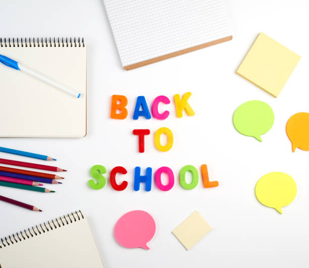 istock inscription back to school from multi-colored plastic letters and a stack of notebooks 1173212876