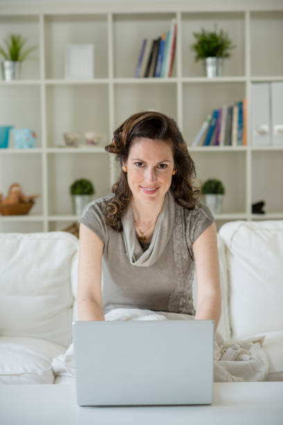 istock Pretty young businesswoman working home on her laptop computer 1173216187