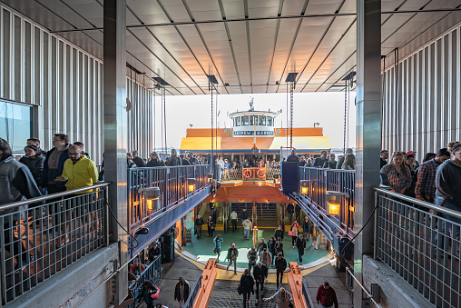 Tourists are going to take their tourboat in Staten Island Ferry Terminal in Downtown manhattan, new york city, USA.