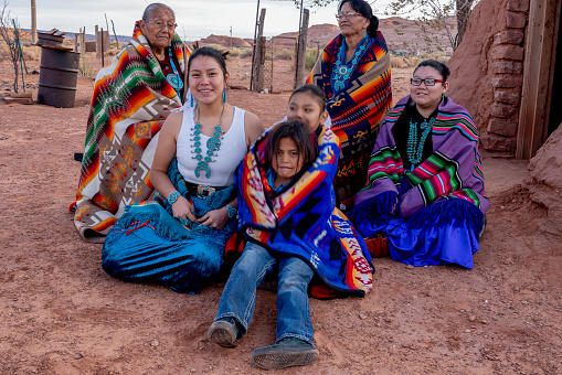 Three Generation Native American Navajo Family with Grandma Great Grandma and Grand children in Monument Valley Arizona