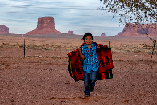 Happy Young Eight Year Old Native American Indian Navajo Board Outside on the Navajo Reservation in Monument Valley Tribal Park in Northern Arizona
