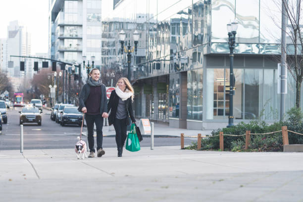 istock Modern couple walking their dog downtown after shopping 1173224924