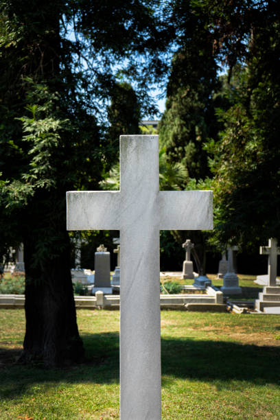istock White stone cross in a cemetery 1173225970