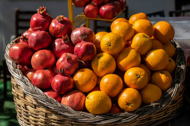 Oranges and Pomegranates in a basket on a sunny summer day