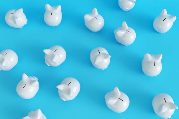 istock Many White Piggy Bank on blue background. top view. minimal concept ideas.