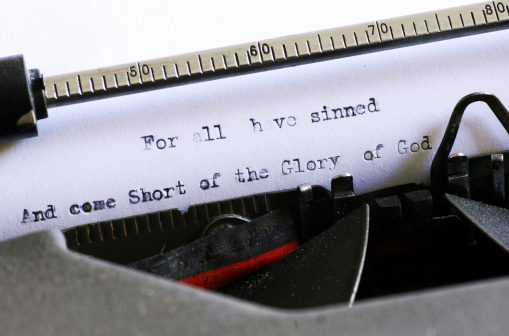 Bible phrase picked out on grungey old typewriter. Macro image.