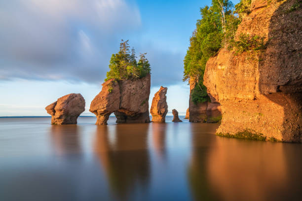 Hopewell Rock, New Brunswick, Canada Hopewill Rock at sunrise during high tide, New Brunswick, Canada maritime provinces stock pictures, royalty-free photos & images