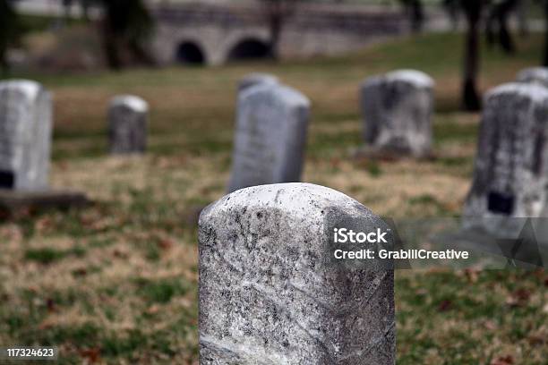 Headsone In Creepy Cemetery With Bridge In Background Stock Photo - Download Image Now