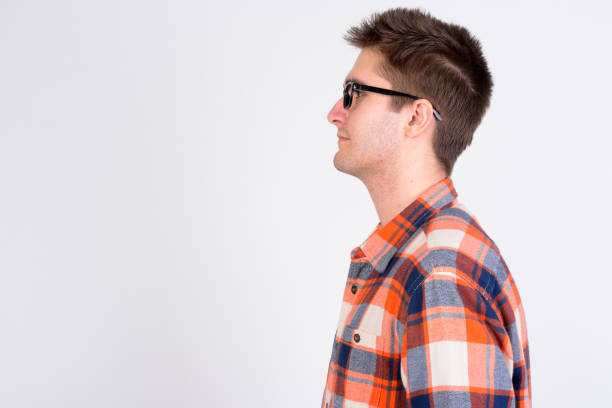 Studio shot of young handsome man looking smart against white background