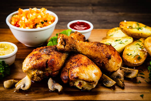 istock Roast chicken legs with fried potatoes and vegetables 1173253372