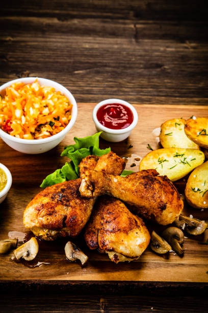 istock Roast chicken legs with fried potatoes and vegetables 1173253386
