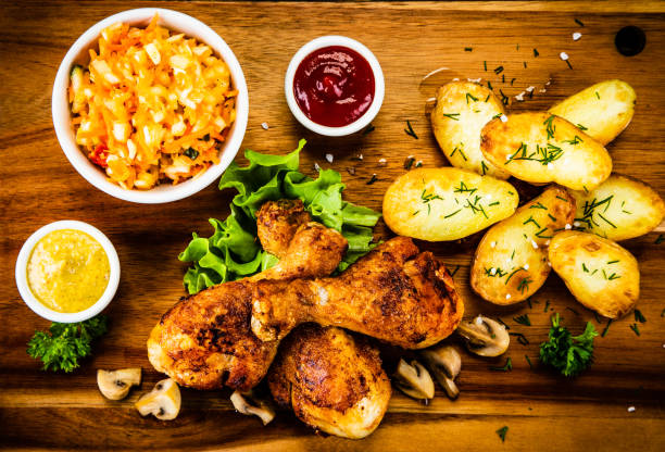 istock Roast chicken legs with fried potatoes and vegetables 1173253406