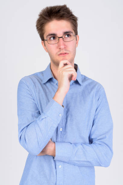 istock Young handsome businessman with eyeglasses thinking and looking up 1173253846
