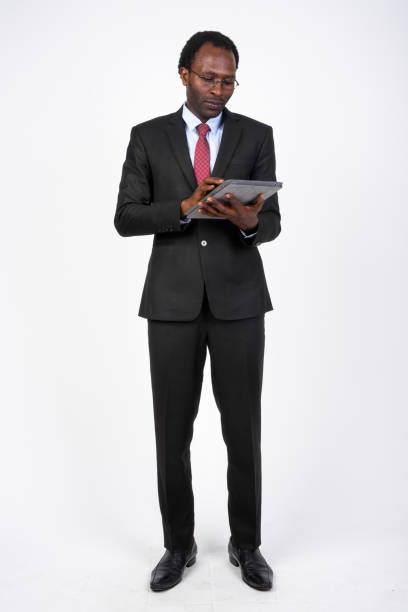 istock Full body shot of African businessman using digital tablet 1173255683