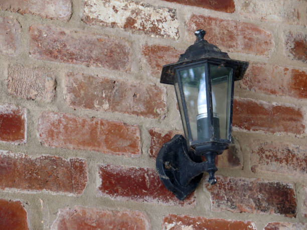 istock Rustic brick wall in Yorkshire village with decorative cast iron wall light 1173255719