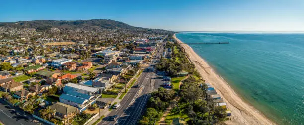 Aerial panorama of Dromana coastline, suburb and pier on bright sunny afternoon