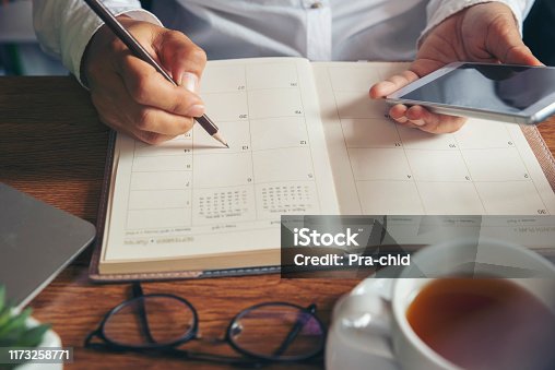 istock Female'hand of planner writing daily appointment. 1173258771