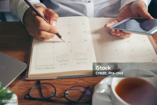 Femalehand Of Planner Writing Daily Appointment Stock Photo - Download Image Now - Personal Organizer, Calendar, Diary