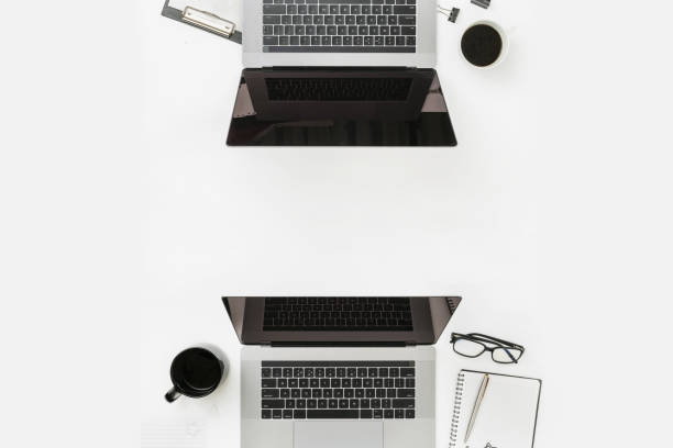istock Minimal freelancer office workplace flat lay top view Worksplase with laptop, notebook, pen, glasses and coffee cup 1173259117