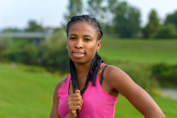 thoughtful young african woman with braided hair - braids african descent women pensive imagens e fotografias de stock