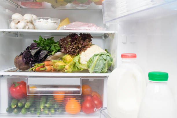 istock open fridge with various food and drinks on the shelves, close-up 1173261859