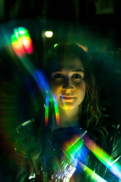 istock Beautiful young woman's portrait with rainbow light reflections 1173263762