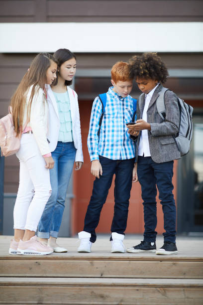 istock Friends with phone outdoors 1173266246