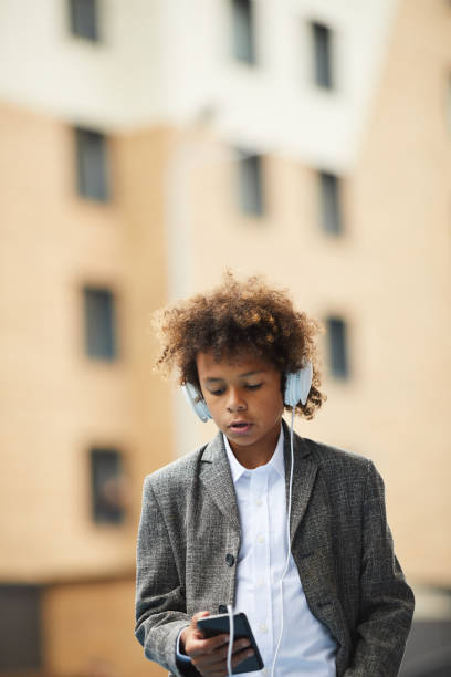 istock Schoolboy talking on mobile phone 1173269809