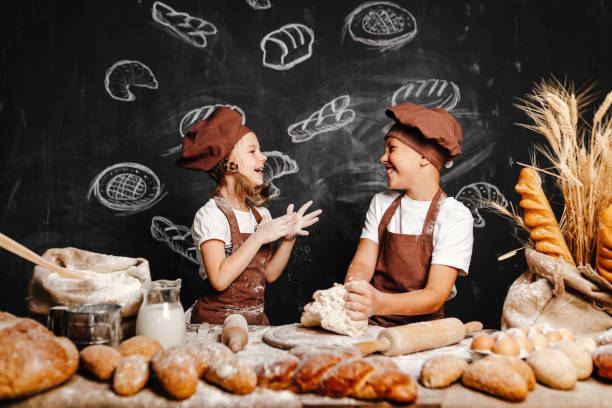 istock Adorable girl with brother cooking 1173270838
