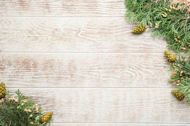 istock Christmas wooden background with fir tree and pine cones. Top view with copy space 1173270849