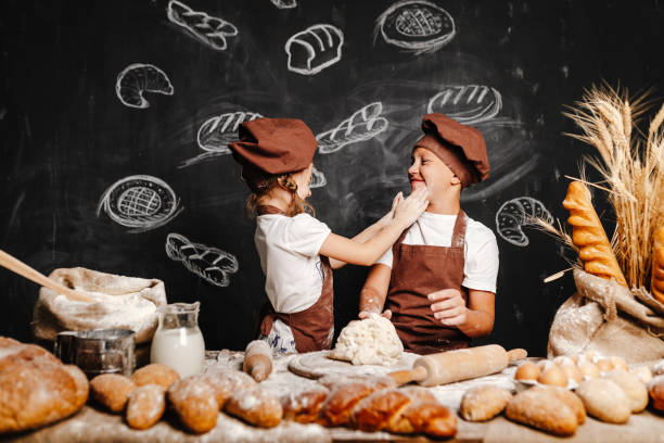 istock Adorable girl with brother cooking 1173270885