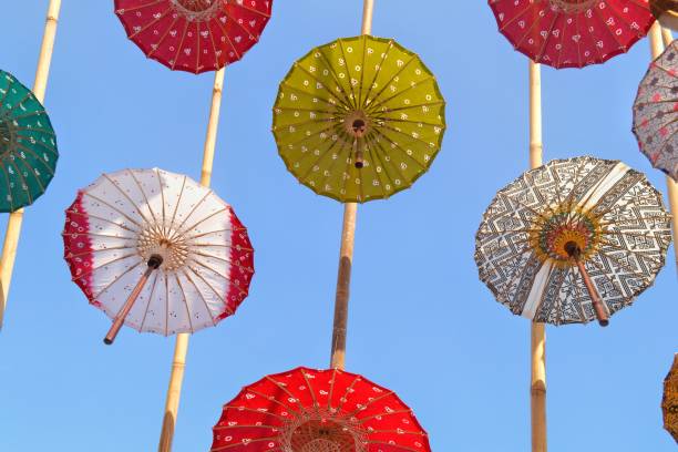 istock Colorful umbrellas in the blue sky 1173273529