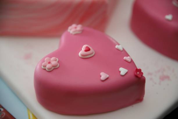 istock Heart shaped pink birthday cake 1173274417