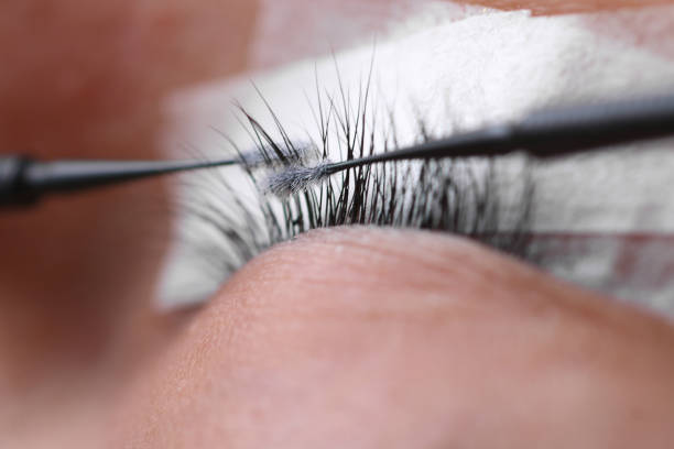 istock Eyelash extension procedure, woman eye with Long eyelashes 1173274692