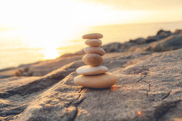 istock Stones pyramid on the seashore at sunset 1173275485