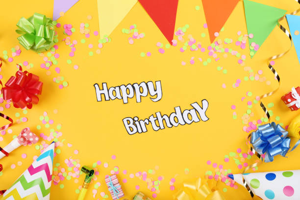 istock Text Happy Birthday with party decorations on yellow background 1173276809