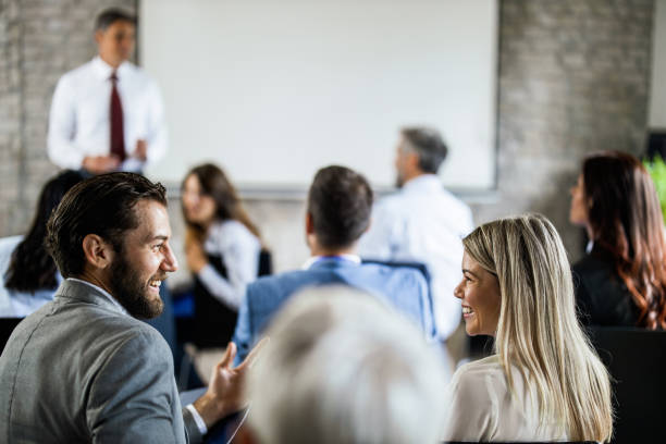 istock Happy entrepreneurs communicating while having business presentation in board room. 1173277024