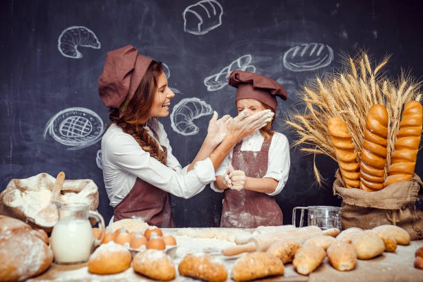 istock Playful child with mother making dough 1173277030
