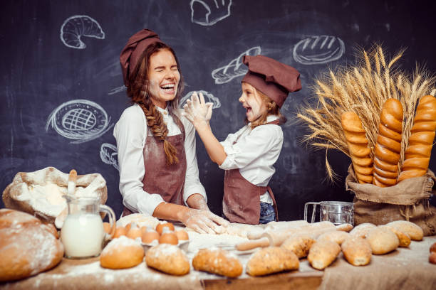 istock Playful child with mother making dough 1173277044