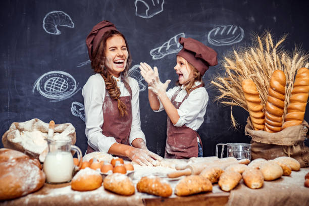 istock Playful child with mother making dough 1173277050