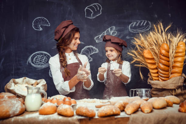 istock Playful child with mother making dough 1173277067