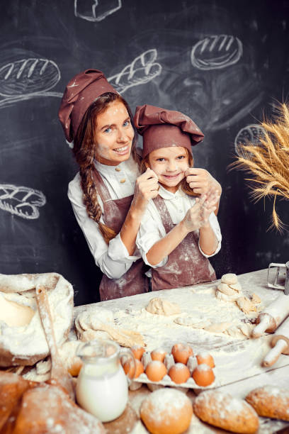 istock Playful child with mother making dough 1173277081