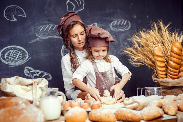 istock Playful child with mother making dough 1173277088