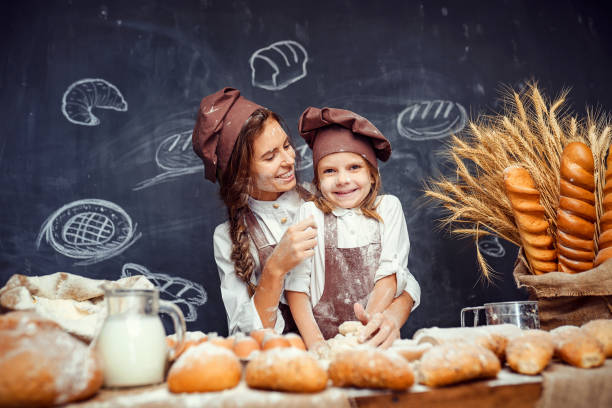 istock Playful child with mother making dough 1173277109