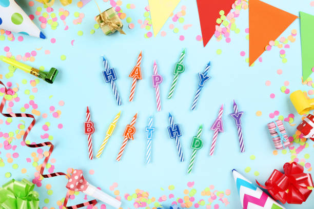 istock Happy Birthday candles with party decorations on blue background 1173277204