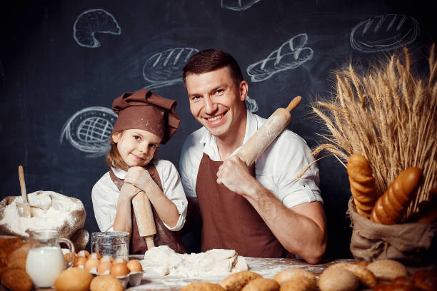 istock Cheerful man with adorable girl holding rolling pins 1173277321
