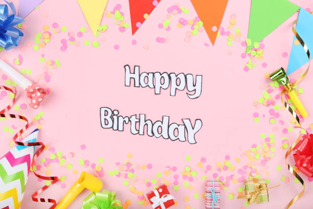 istock Text Happy Birthday with party decorations on pink background 1173277322