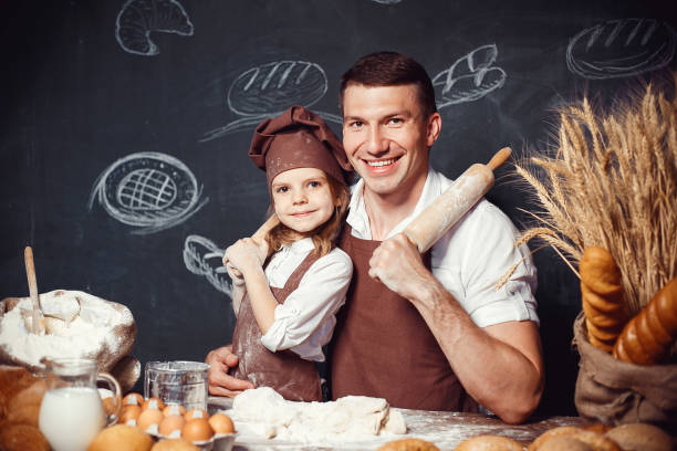 istock Cheerful man with adorable girl holding rolling pins 1173277335