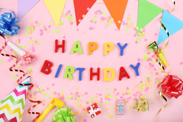 istock Text Happy Birthday by plastic letters with decorations and confetti on pink background 1173277338